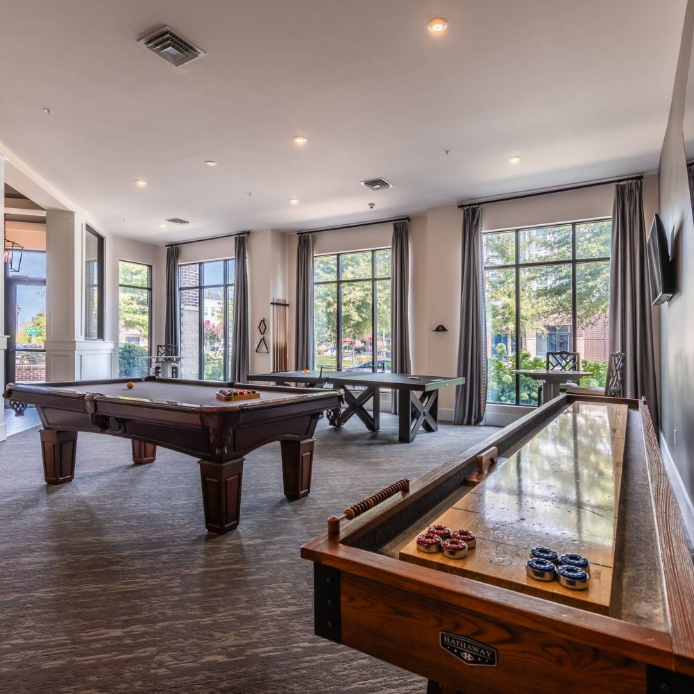 Apartments at Holly Crest Luxury game room amenity with shuffleboard and pool tables